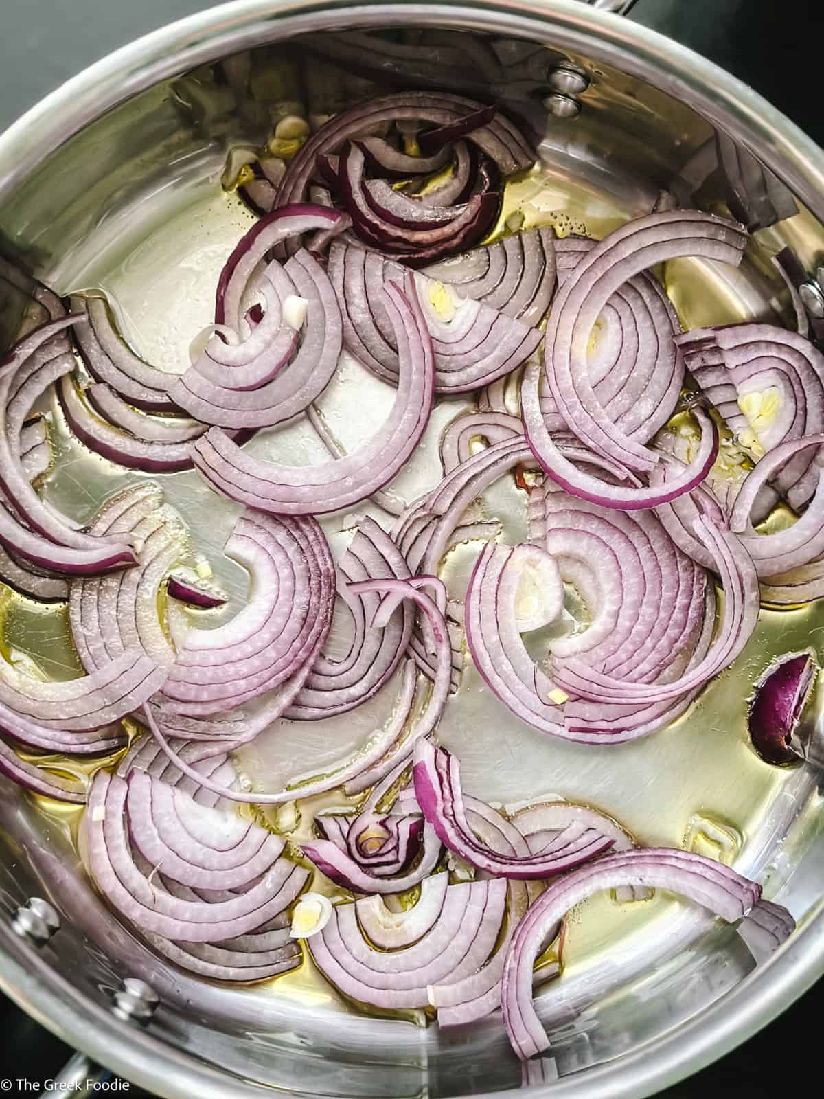 Sliced onions in a frying pan.