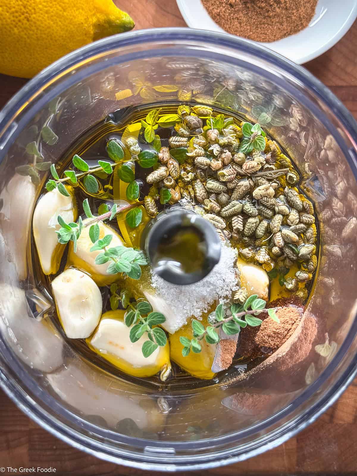 Garlic, herbs, olive oil, in a food processor.
