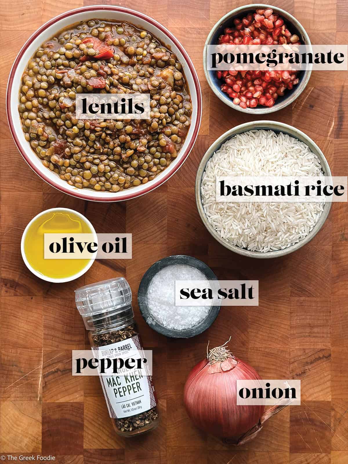 Leftover lentils, pomegranate, onion, rice, olive oil, salt and pepper on a wooden surface