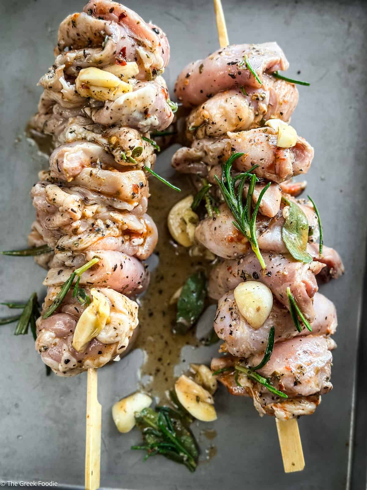 Chicken skewers in a roasting pan.