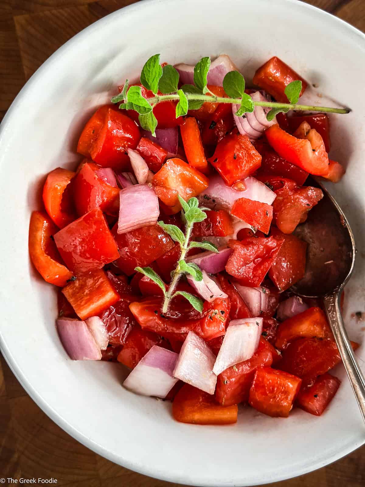 Diced tomatoes, bell pepper and onion in a bowl.