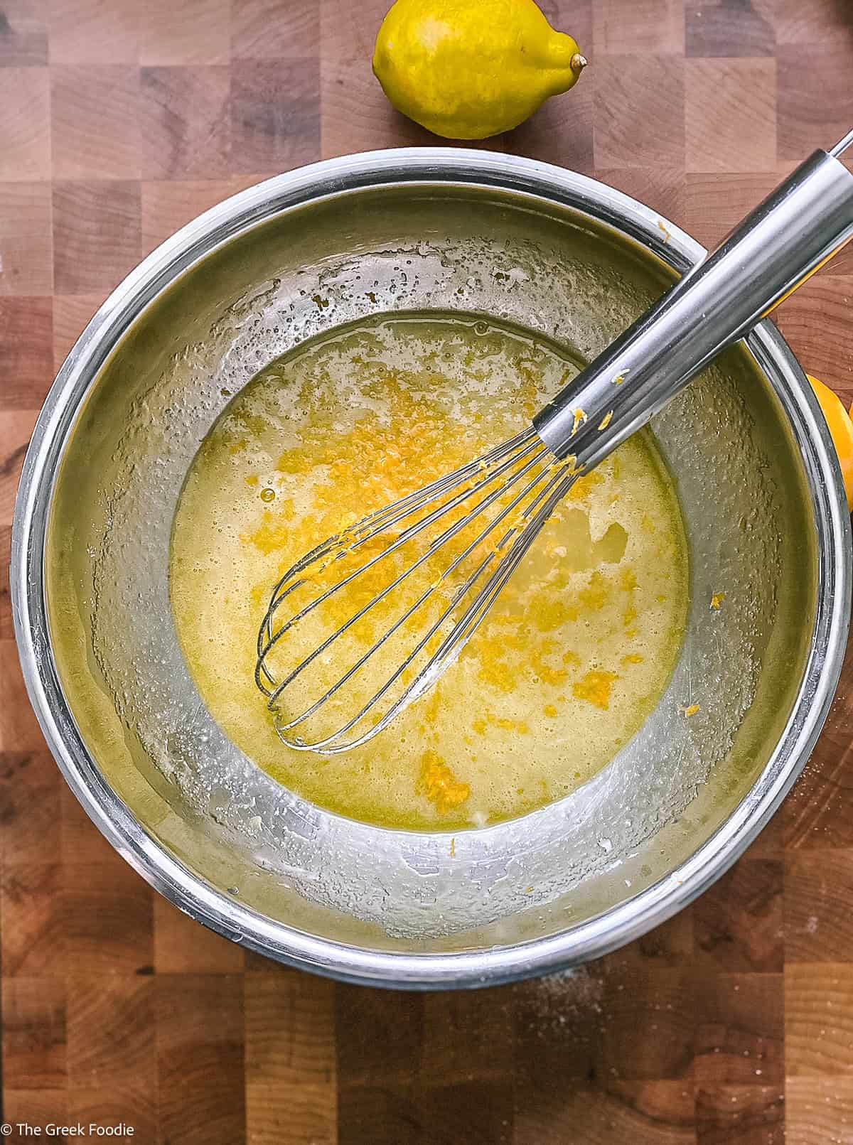 Cake batter in a bowl with a whisk.