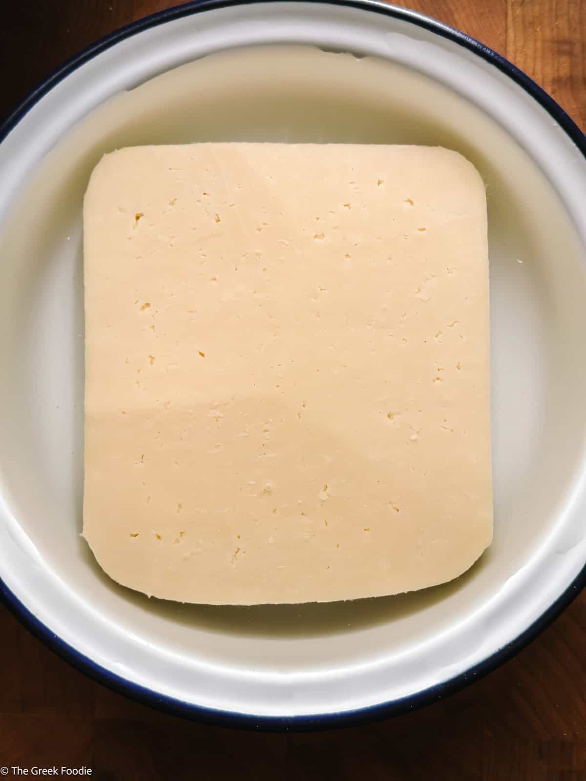 A piece of cheese in water.