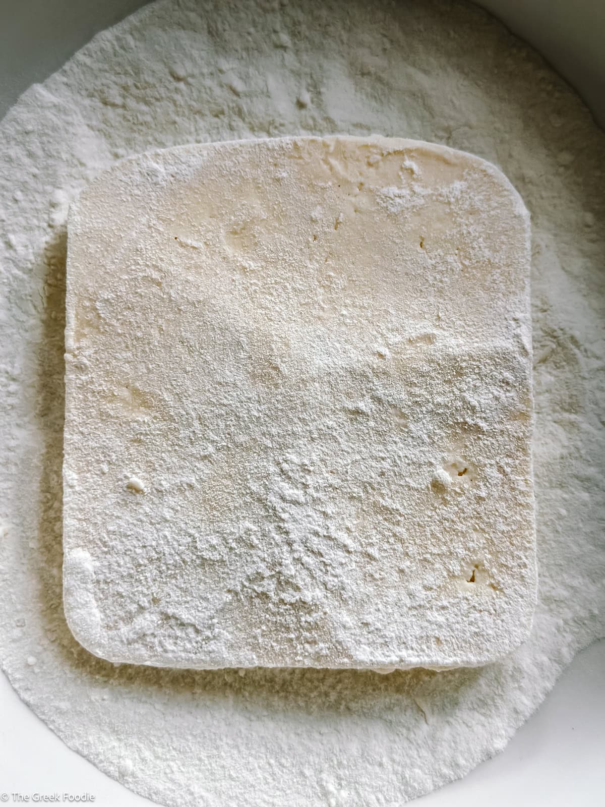 A piece of cheese in flour.