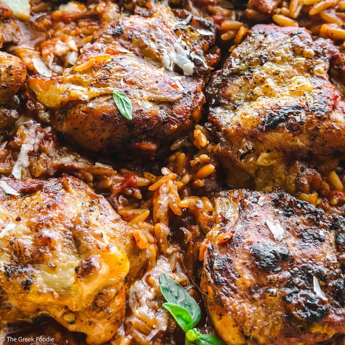 Close up of a skillet with Greek chicken orzo-Giouvetsi.