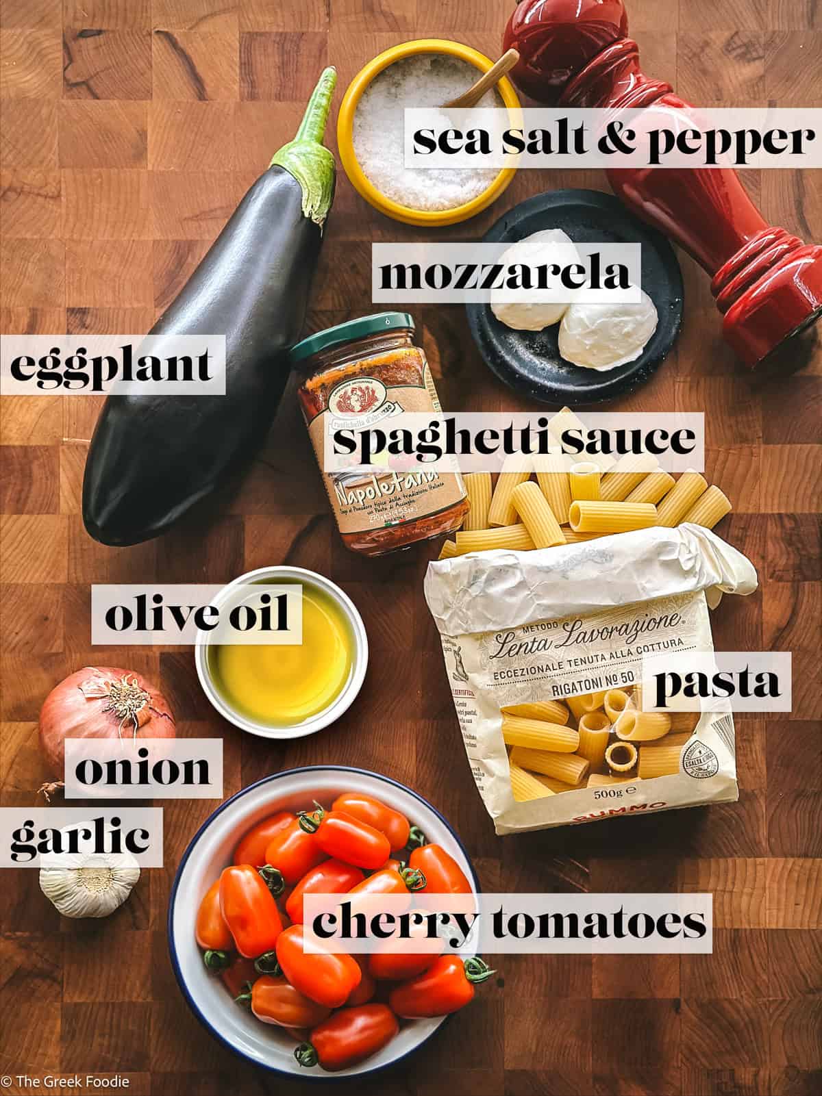 Ingredients for making eggplant pasta with cherry tomatoes, onions, and olive oil.