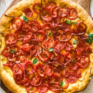 A Ladenia olive oil pie, Greek pizza on a wooden board.