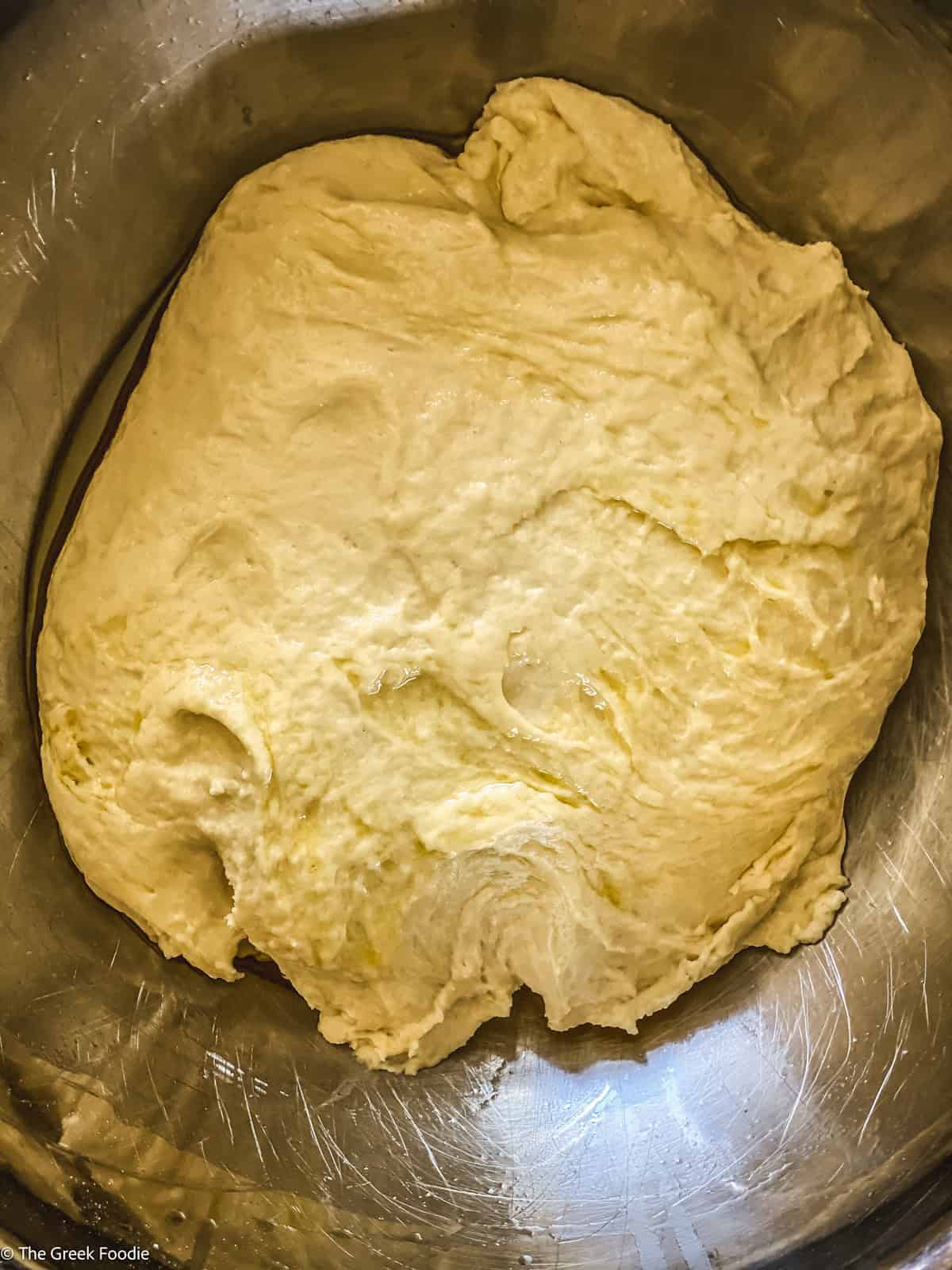 Pizza dough in a bowl.