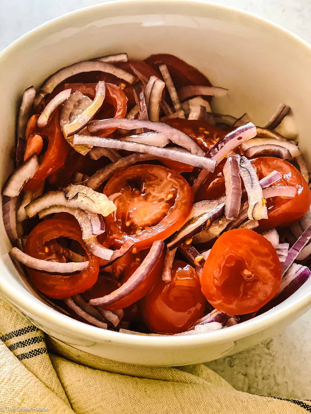 Tomatoes and onions in a bowl.
