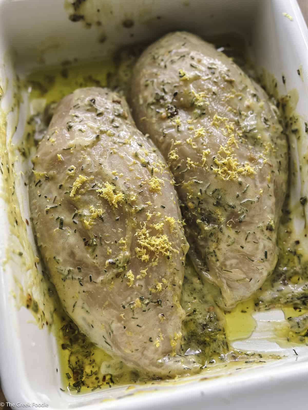 Chicken in a pan with marinade.