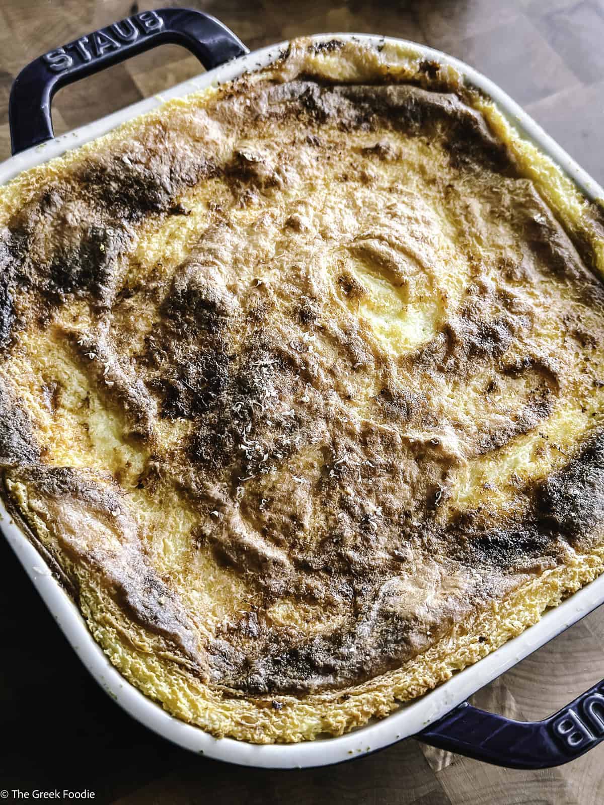 A cooked vegetarian moussaka on a working surface.