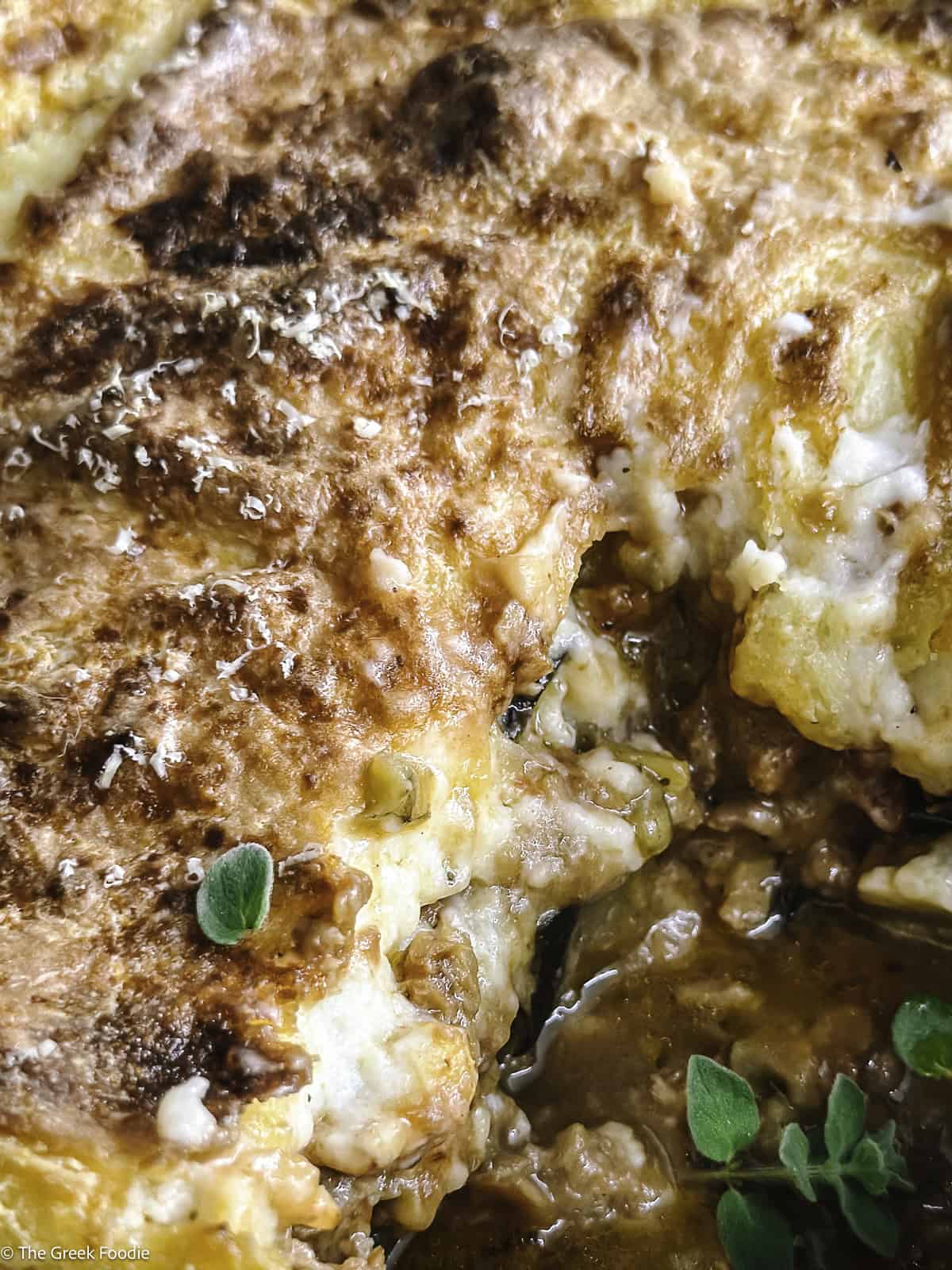 A vegetarian moussaka in a baking pan with a piece taken out .
