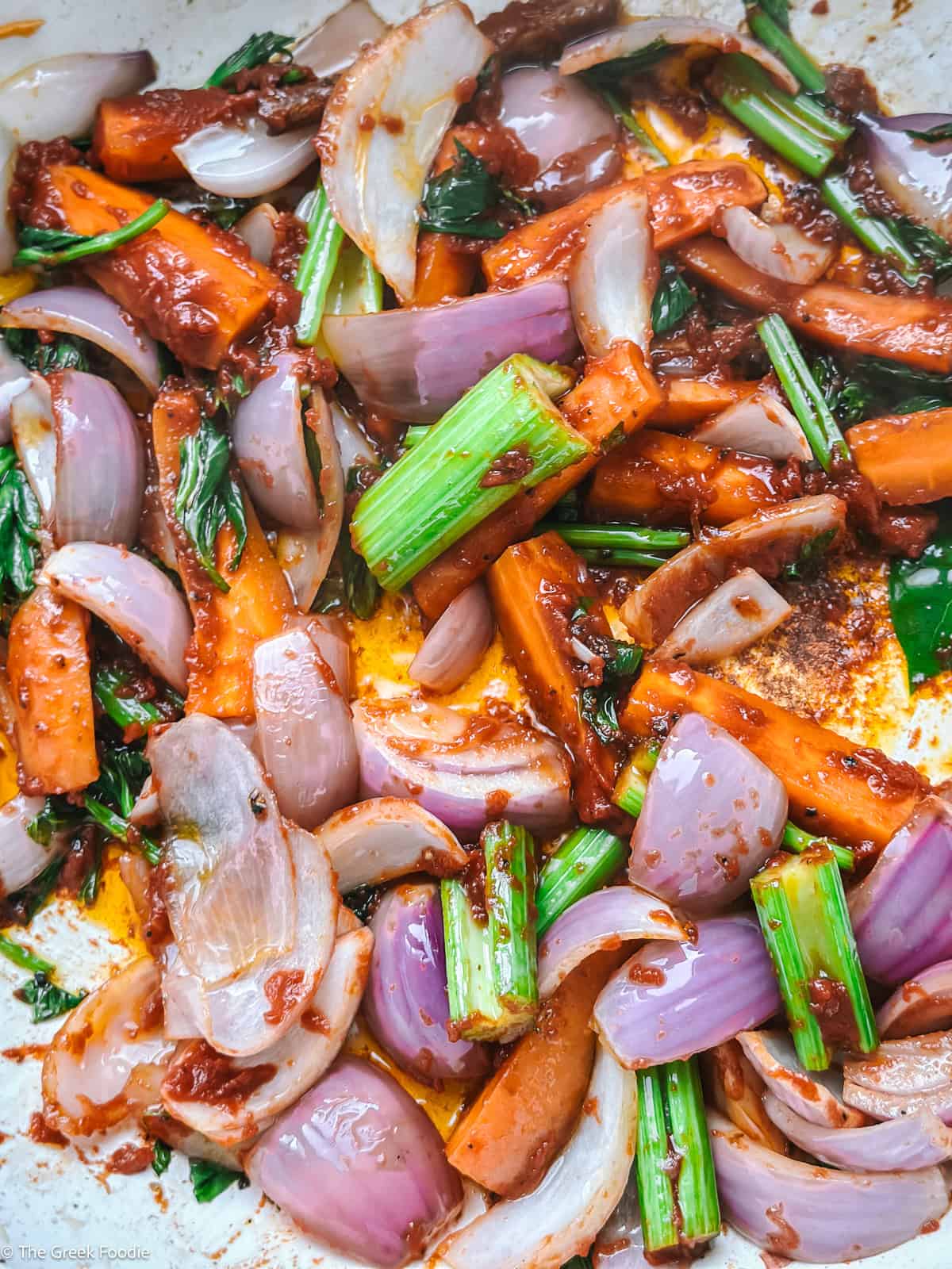 Onion, celery, and carrots in olive oil in a pan.