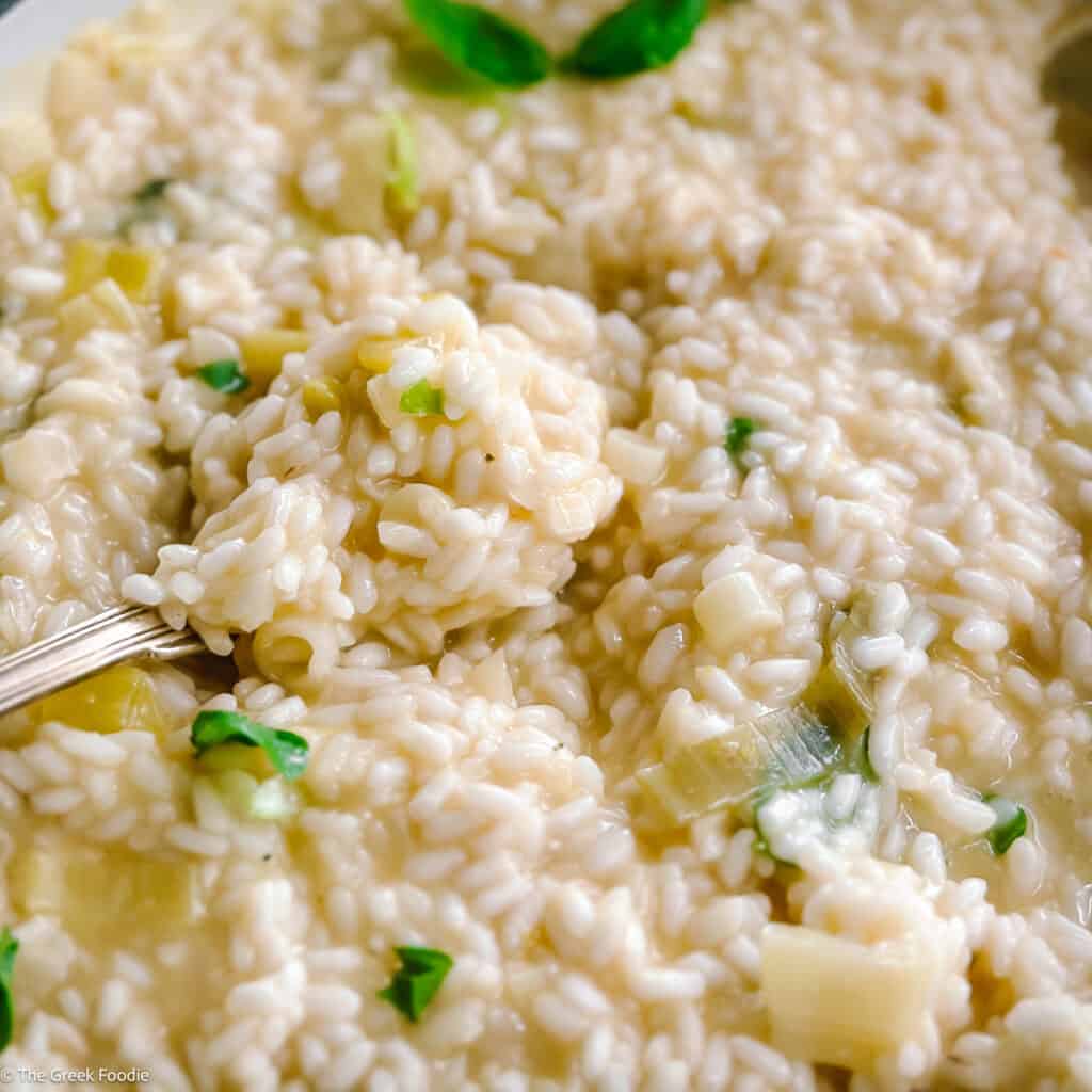 Creamy lemon herb risotto and a spoon.