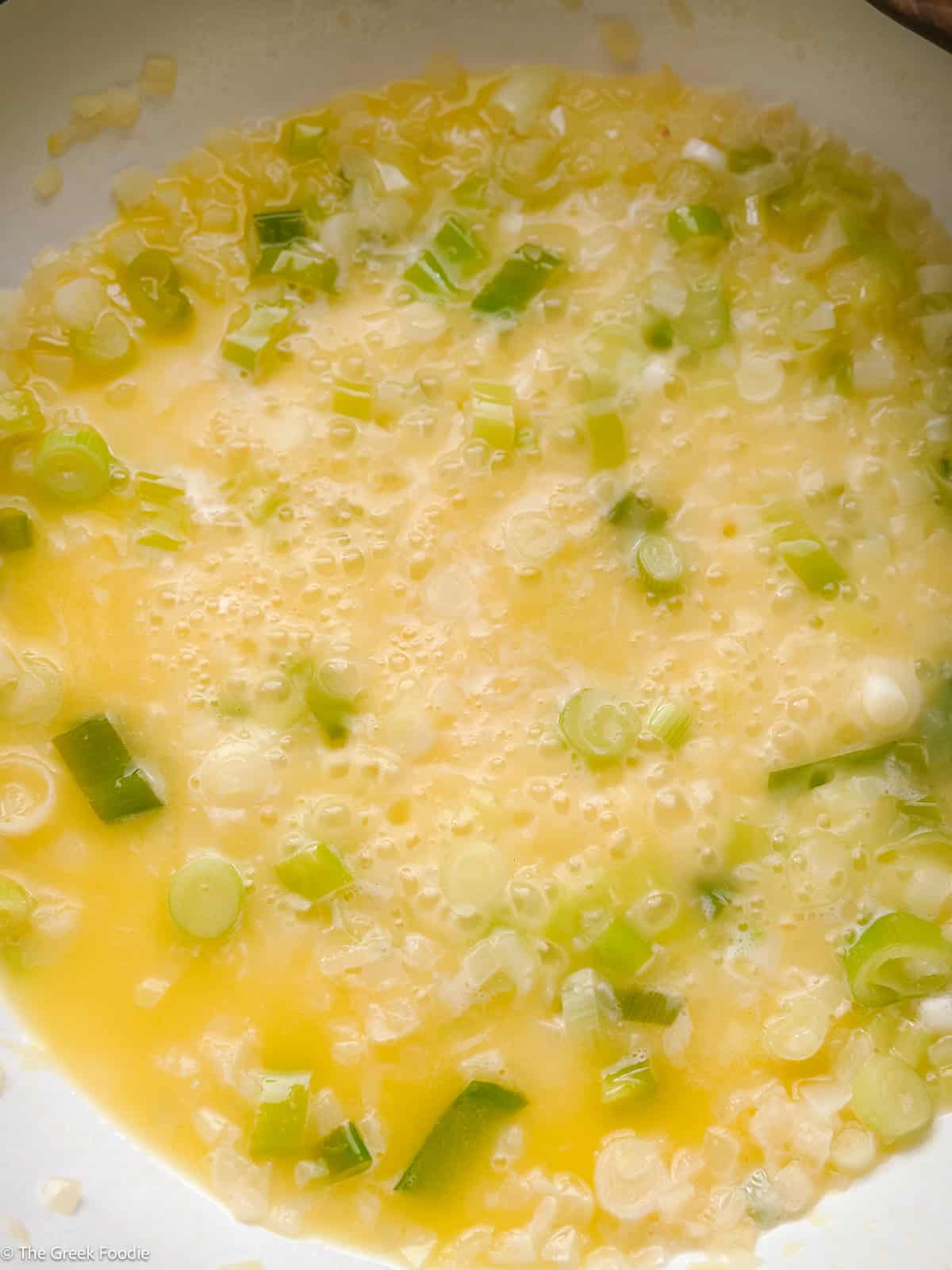 Onions and spring onions in butter and wine cooking.