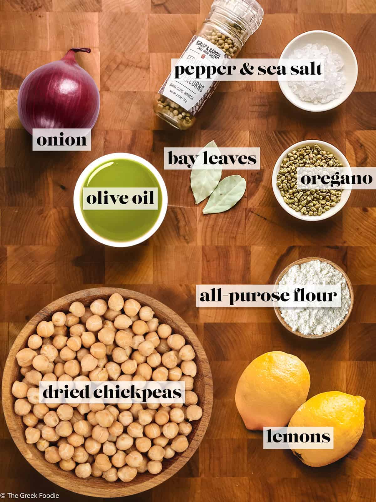 Ingredients to make greek chickpea soup on a cutting board.