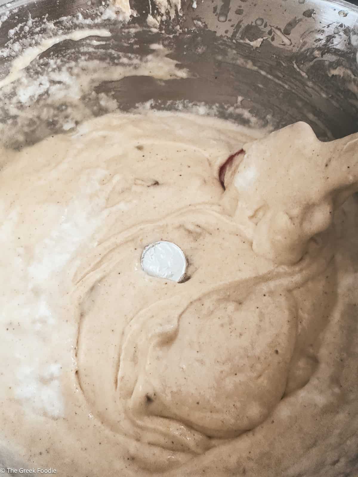 Cake batter with an aluminum foil coin.