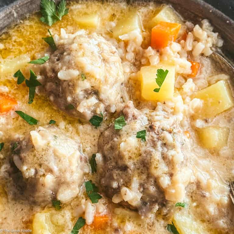 Youvarlakia meatballs with rice, broth in a plate.
