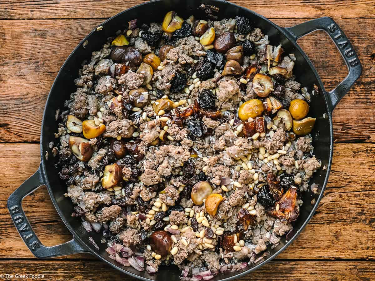 Greek turkey stuffing in a dutch oven skillet on a table.