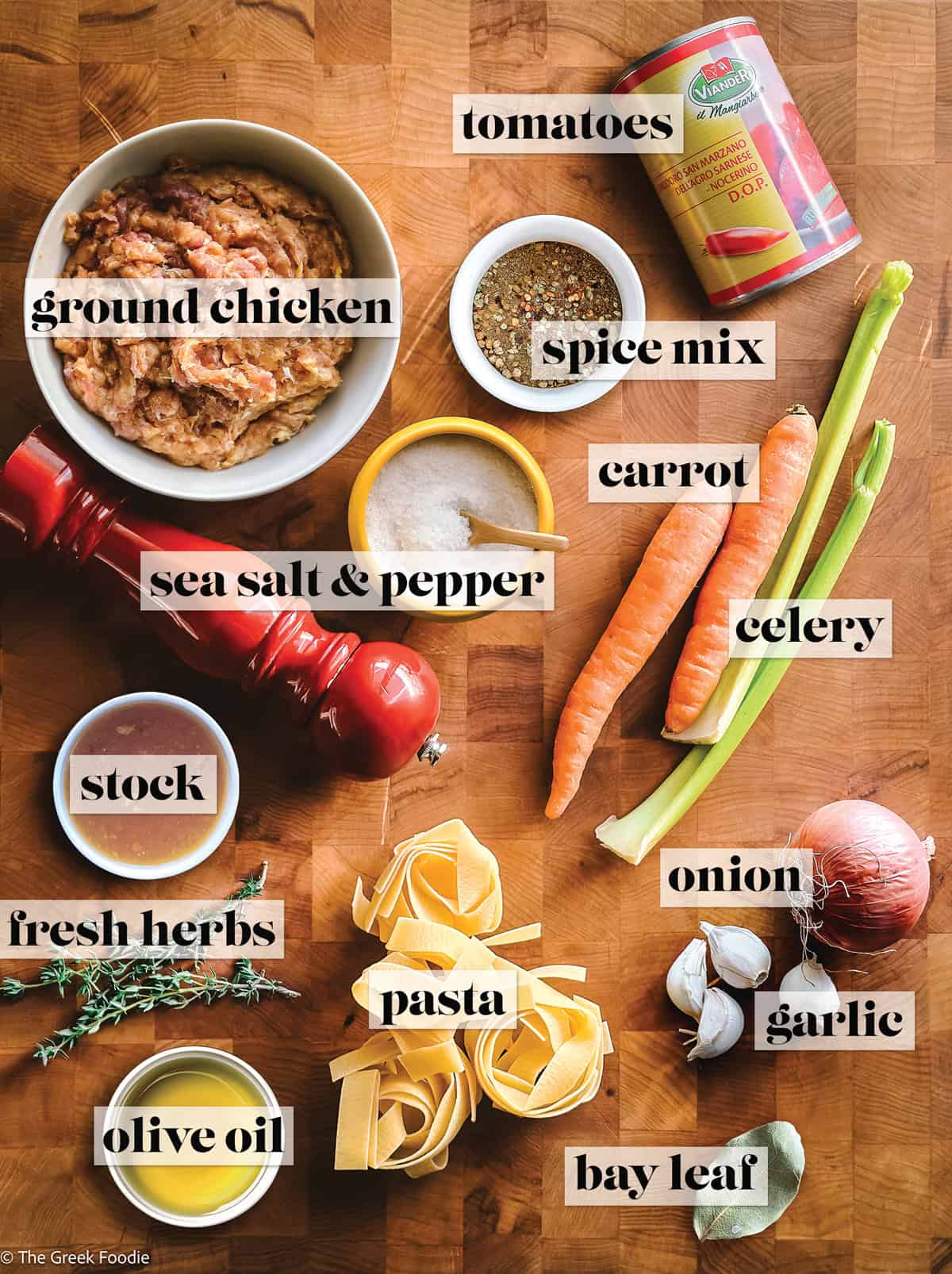 Ingredienst on a wooden surface for making chicken pappardelle.