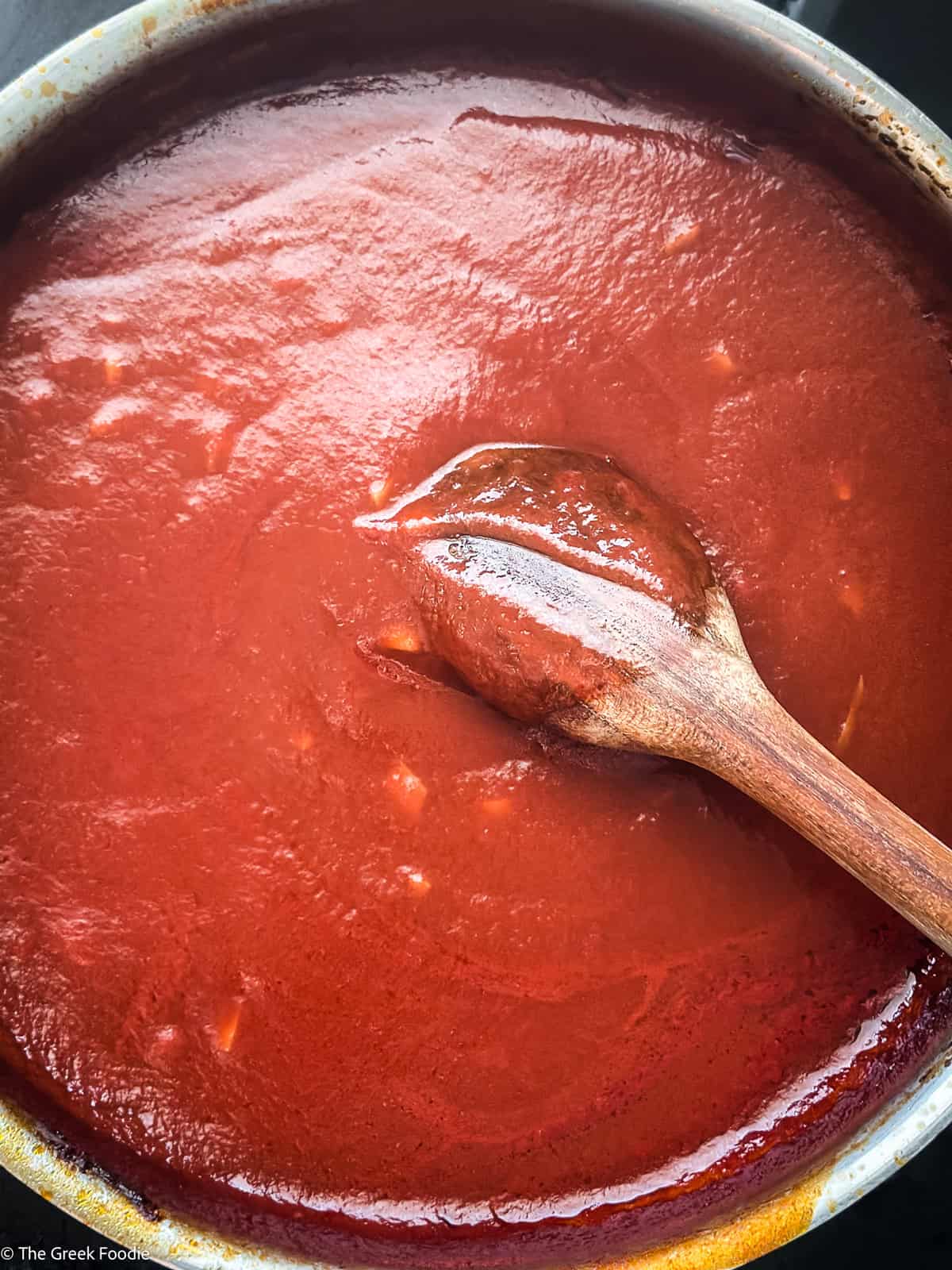 Thick homemade tomato sauce simmered for Greek melitzanosalata.