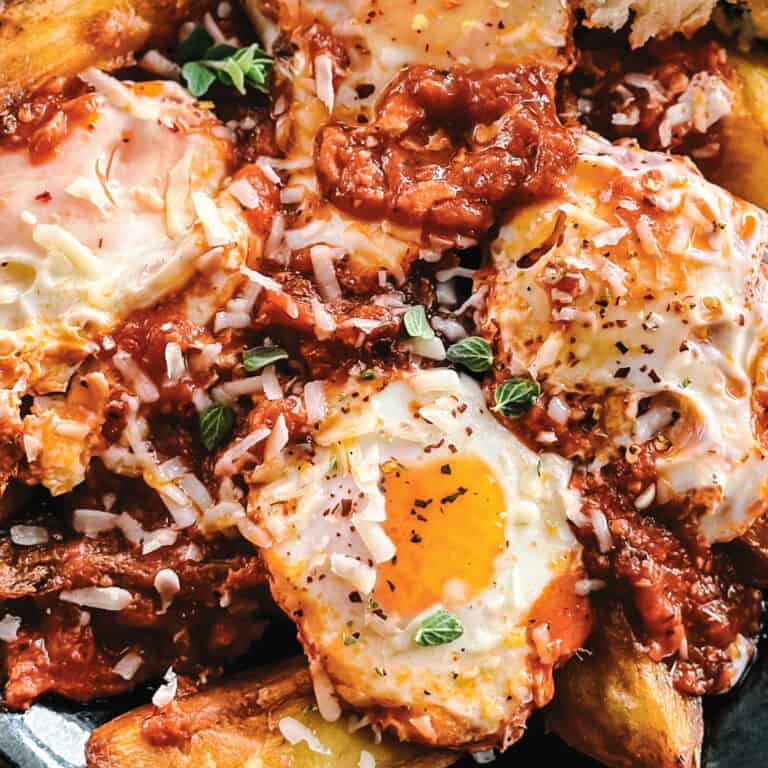 Greek eggs simmered in tomato sauce served over crispy potato wedges and finished with graviera, oregano, and chili flakes.