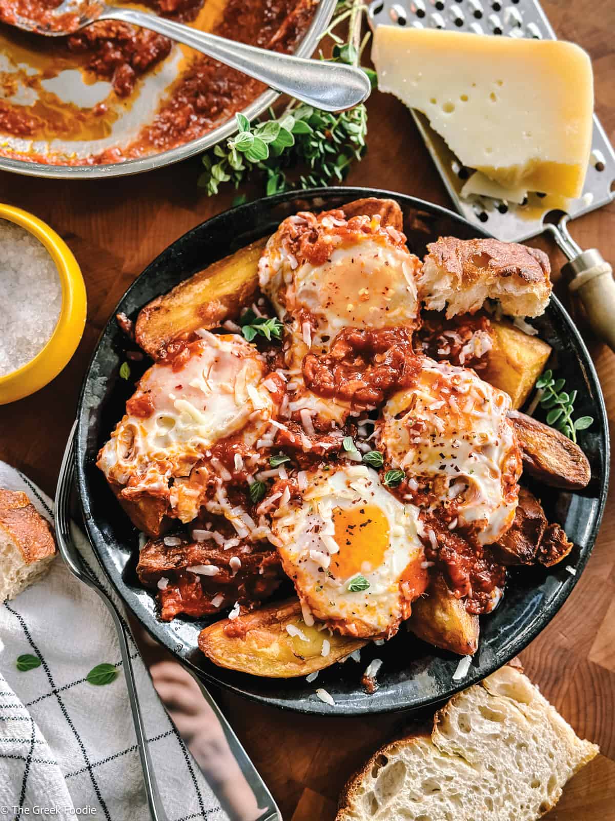 Greek eggs simmered in tomato sauce served over crispy potato wedges and finished with graviera, oregano, and chili flakes.