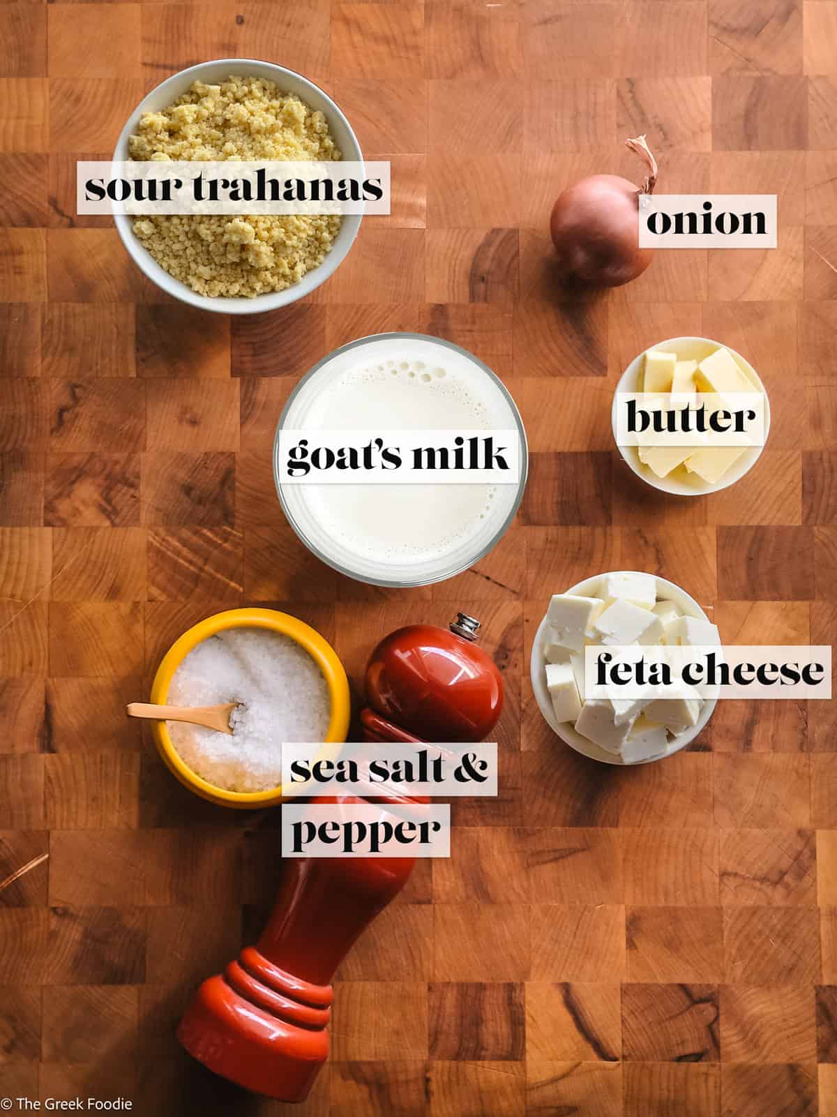Ingredients for traditional Greek trahanas soup including sour trahanas, goat’s milk, butter, feta cheese, onion, sea salt, and black pepper.