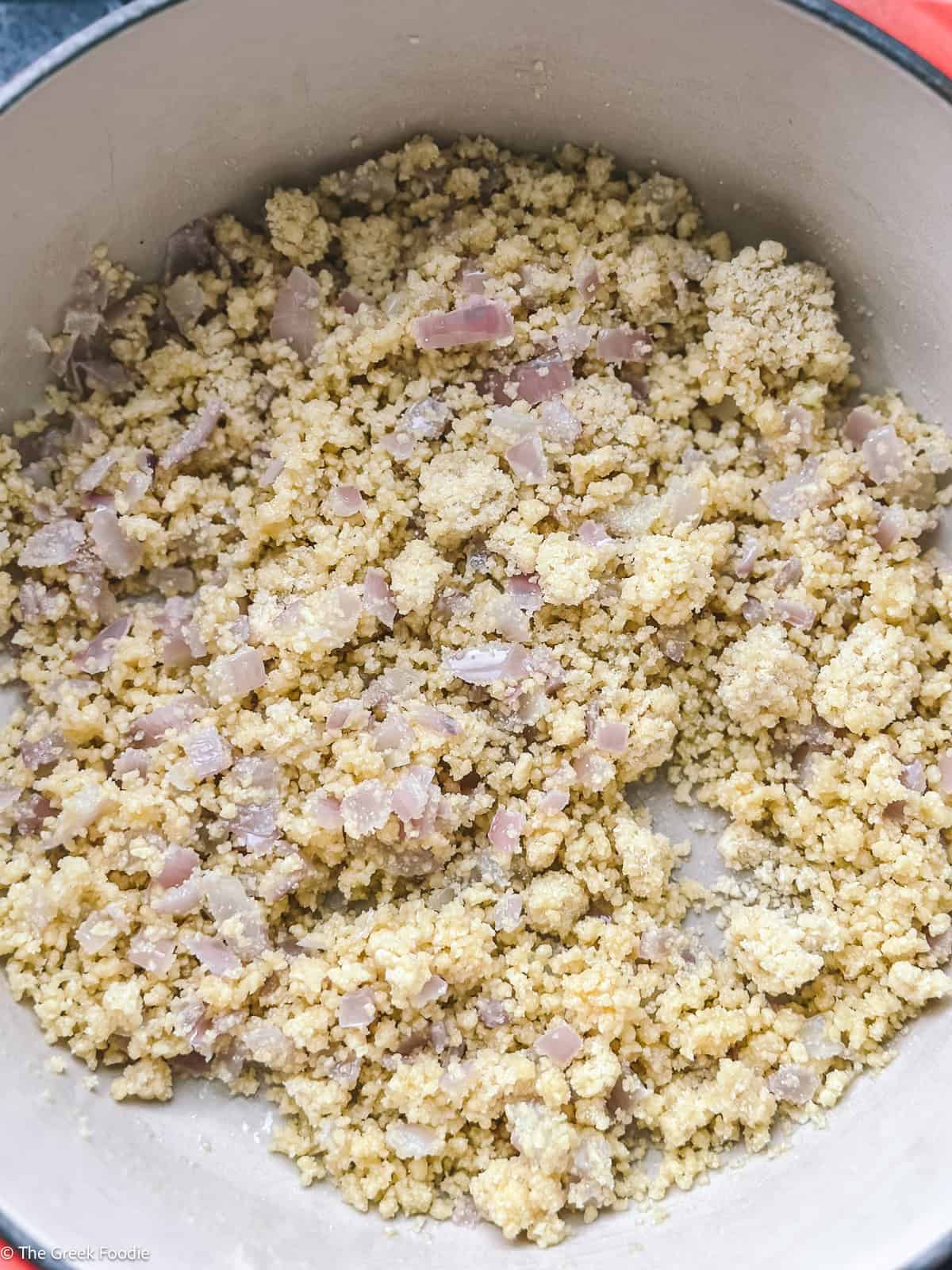 Sour trahanas toasted with sautéed onion in butter before adding liquid.