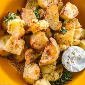 Extra-crispy roasted potato chunks with golden edges, seasoned with dried oregano and olive oil.
