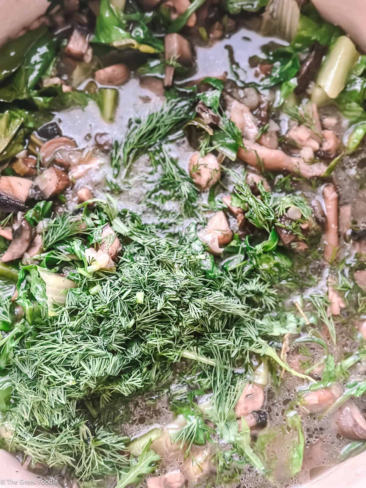 Fresh dill added to vegetarian mushroom magiritsa Greek Easter soup
