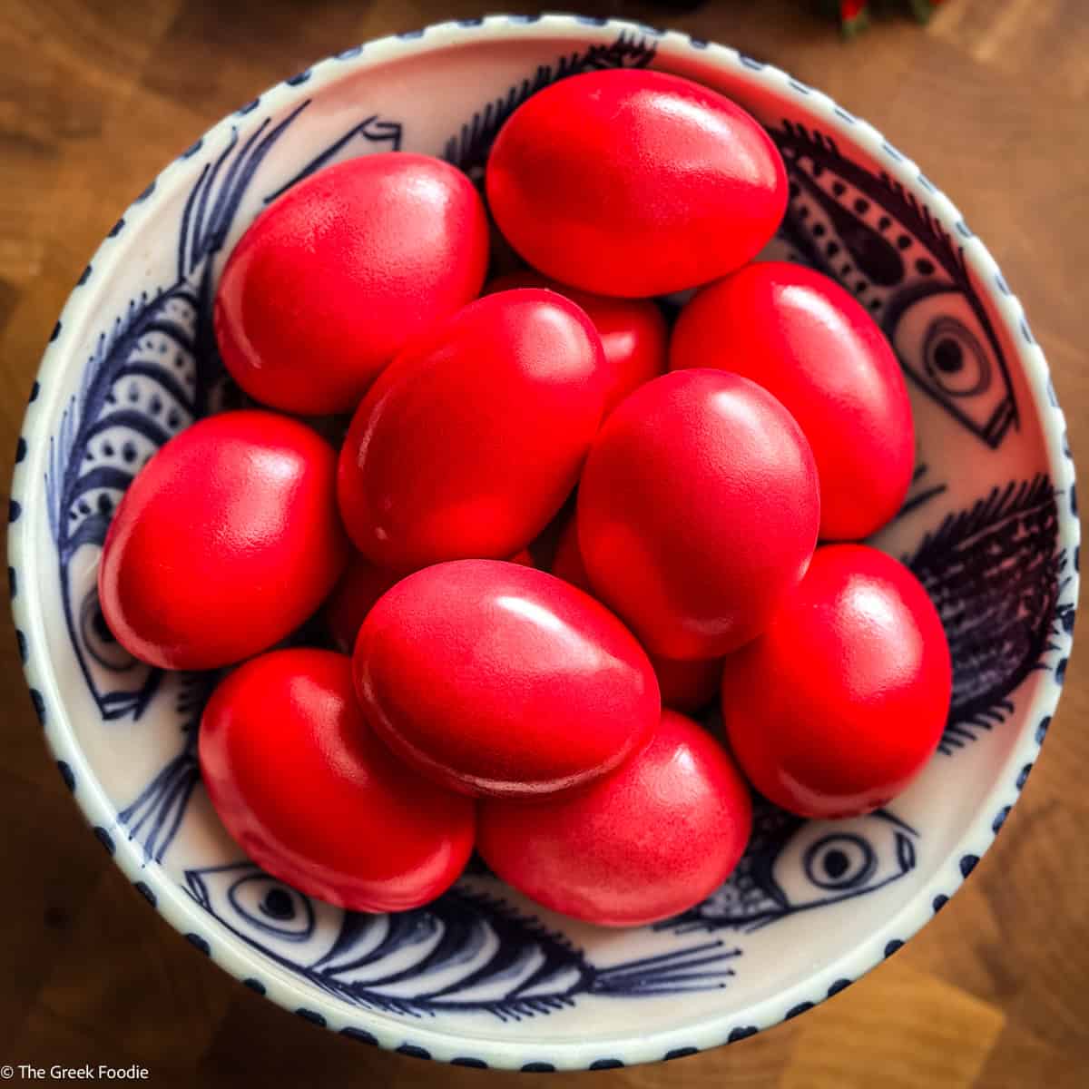 Overhead shot of Greek red Easter eggs in a blue and white bowl