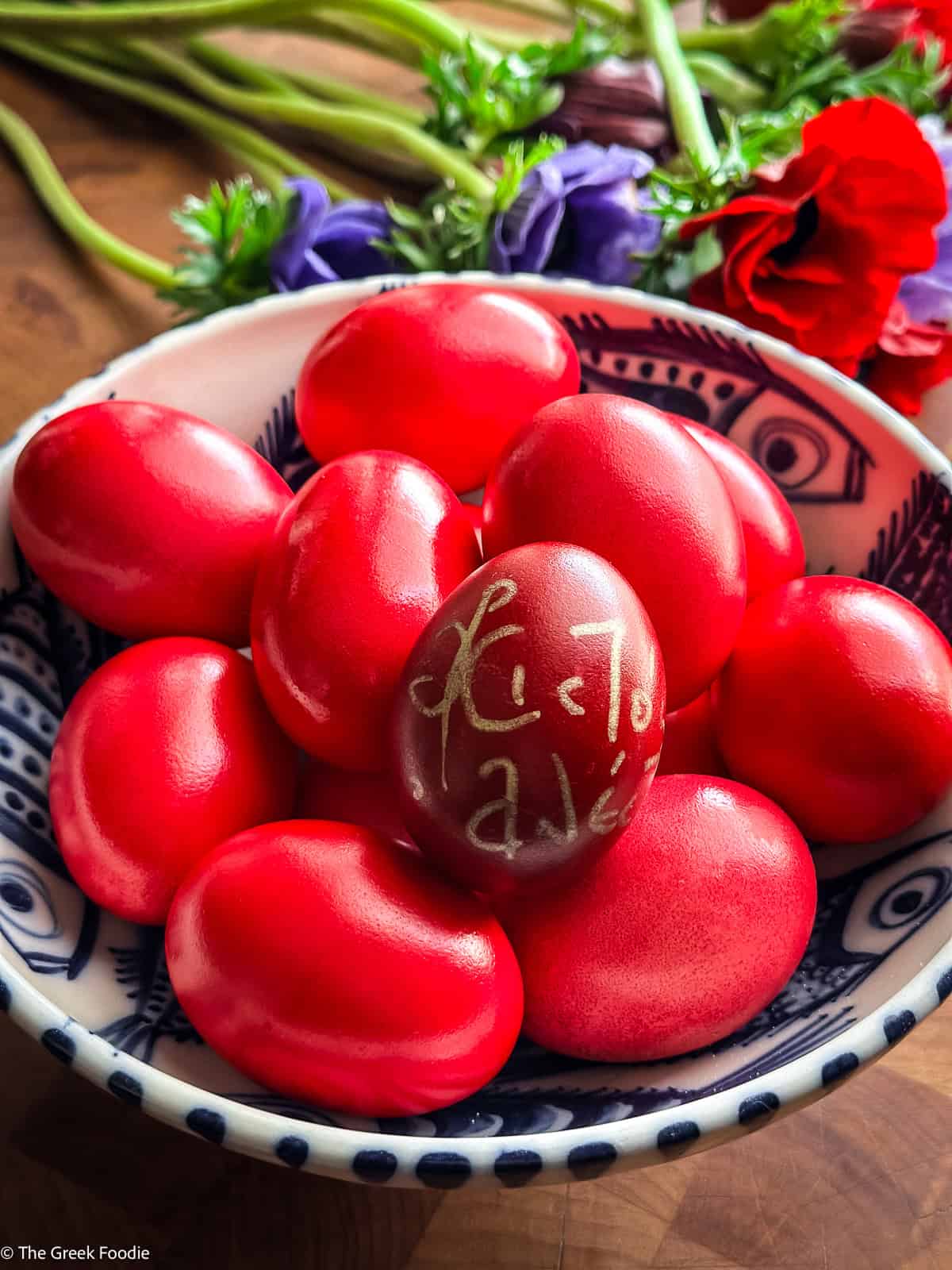 Greek red Easter eggs with Χριστός Ανέστη inscription in a decorative bowl