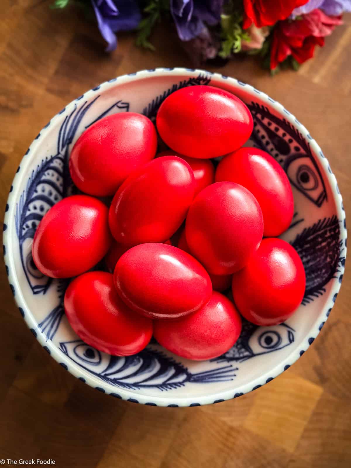 Overhead shot of Greek red Easter eggs in a blue and white bowl
