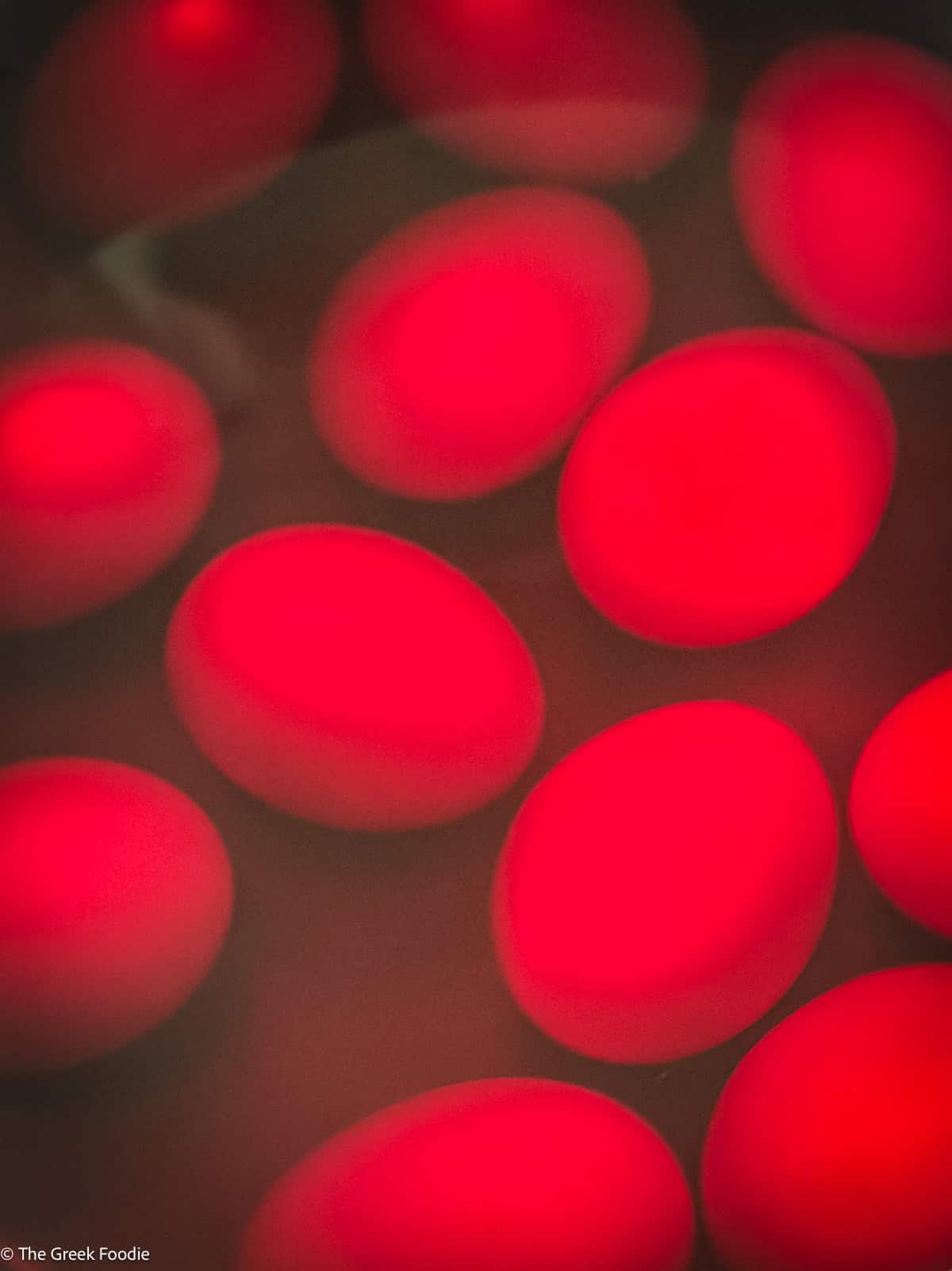 Dyeing Greek Easter eggs red — eggs in the dye bath