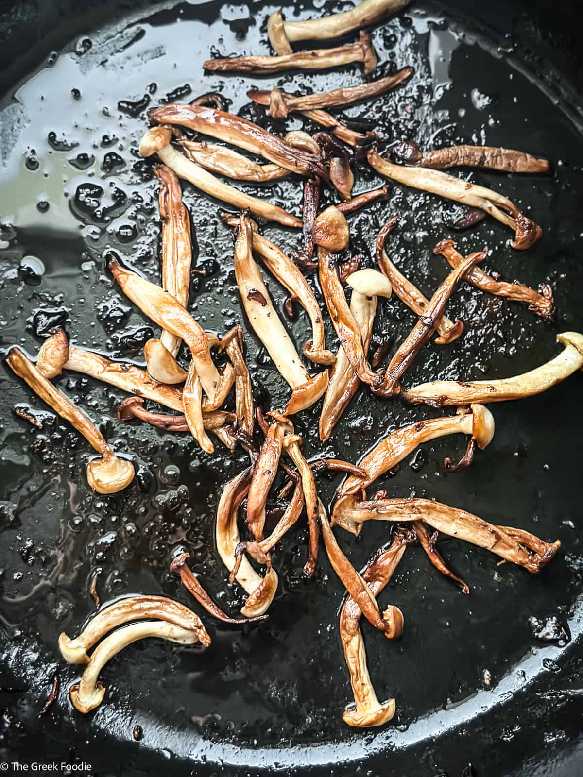 Shimeji mushrooms sautéed until golden for vegetarian magiritsa soup