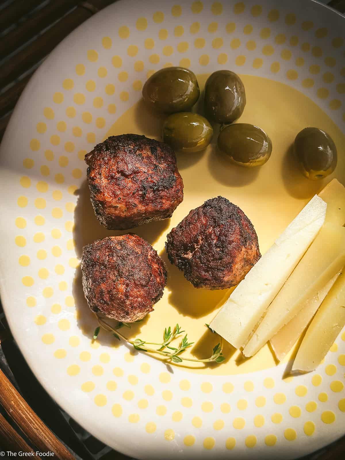 Traditional Greek keftedes served with graver and olives for a quick meze with ouzo