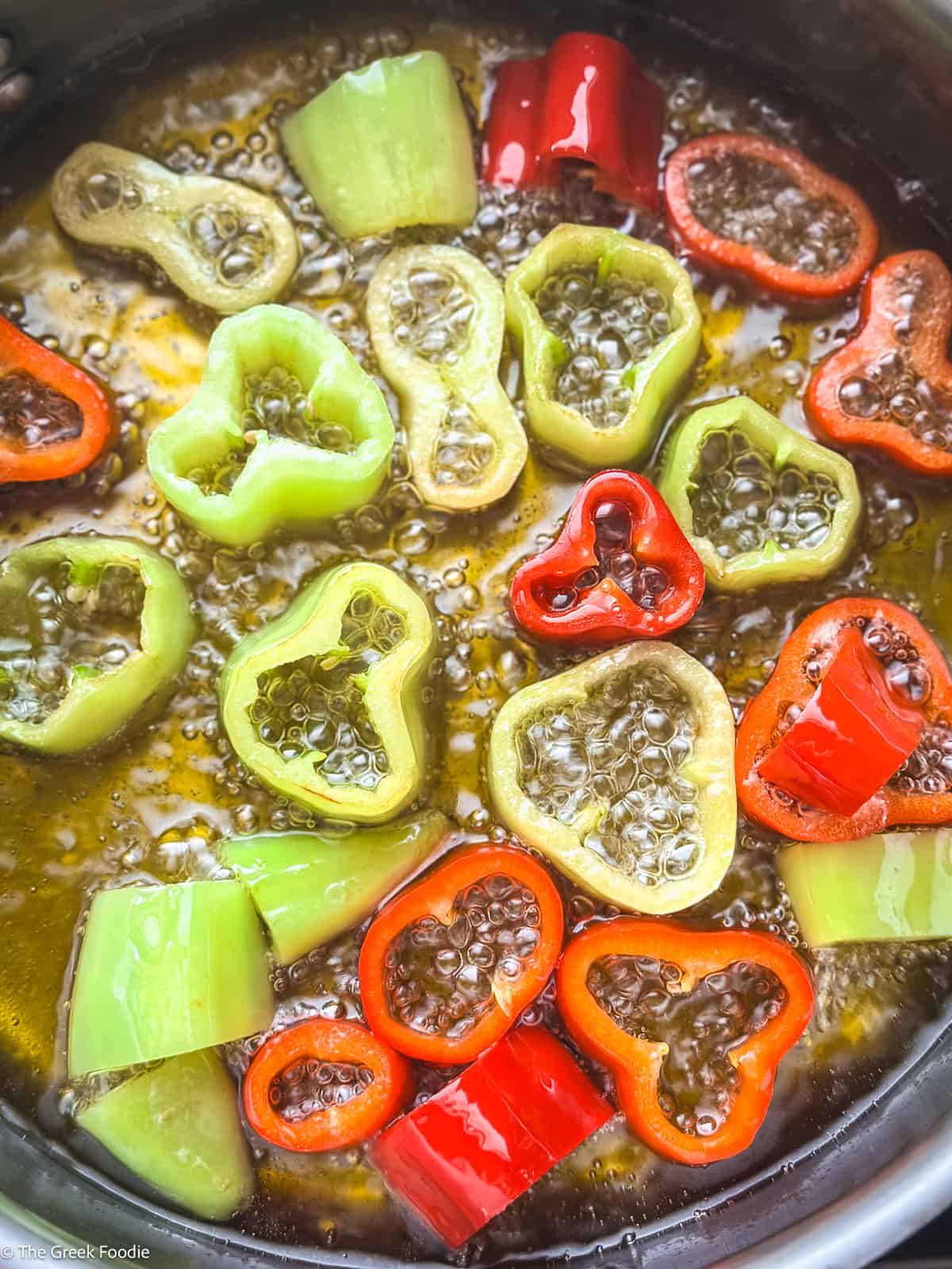 Florina and green peppers frying in olive oil — the first step in making authentic Greek spetzofai
