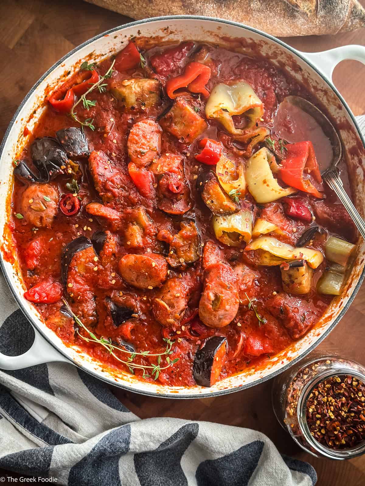 Overhead view of spetzofai, the spicy Greek sausage and peppers stew, in a cast iron pot
