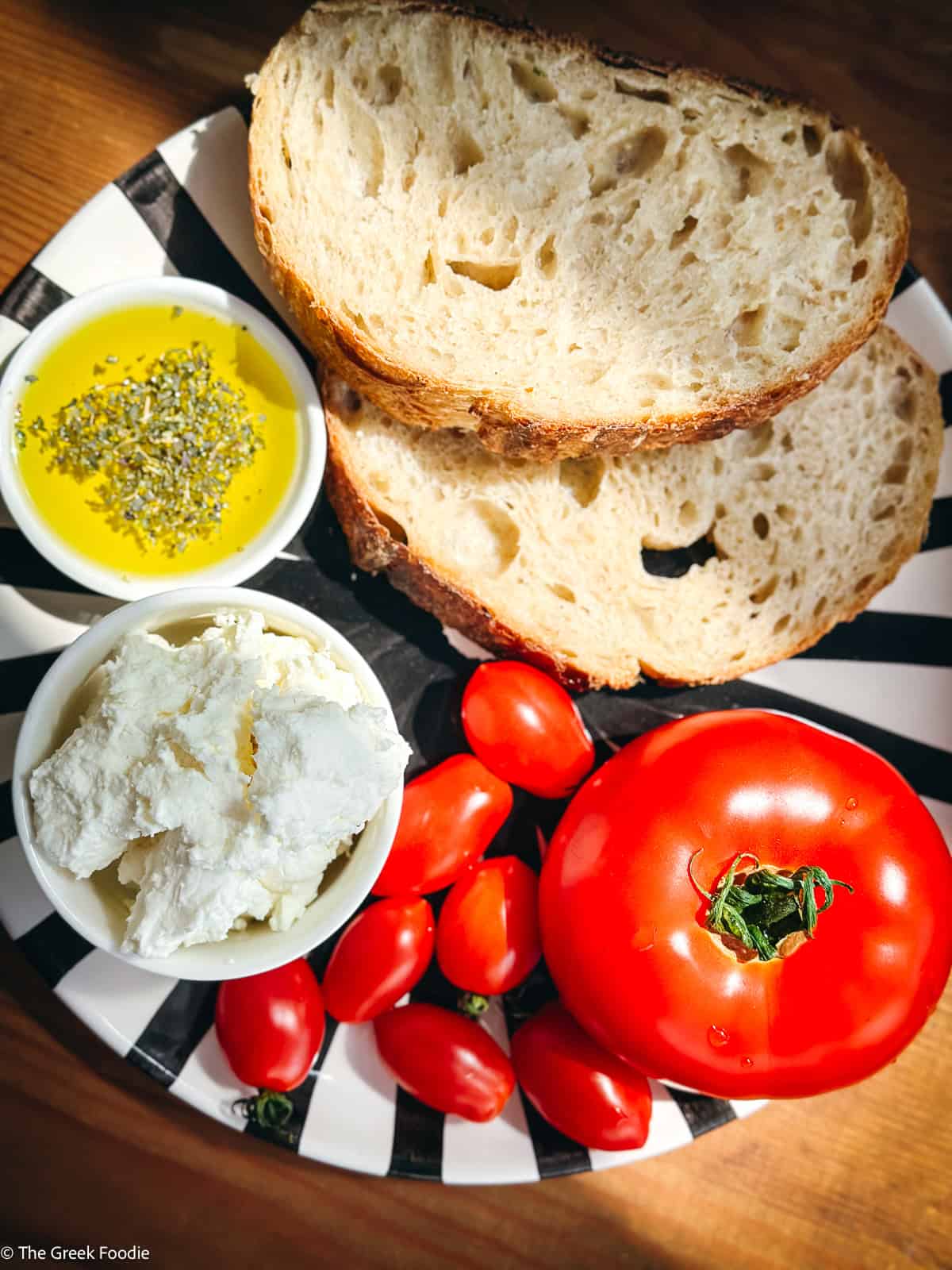ngredients for tomato toast — sourdough bread, fresh tomatoes, mizithra cheese, and olive oil with oregano