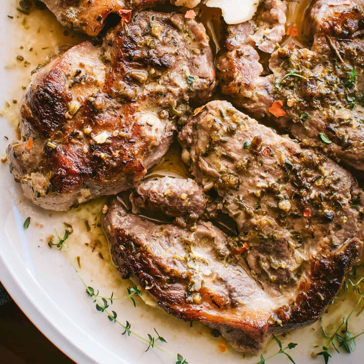 Boneless Greek pork steaks with lemon oregano pan sauce and fresh herbs