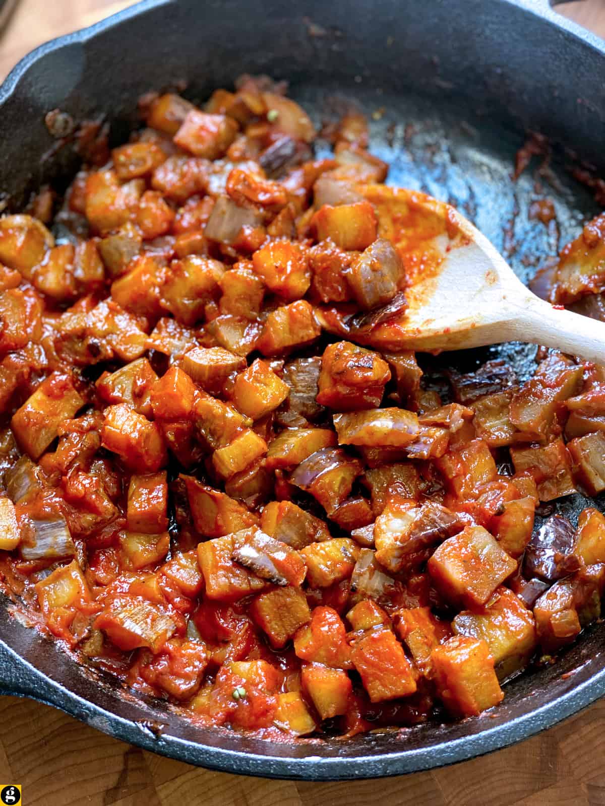 Finished Greek-style eggplant topping in a cast iron skillet.