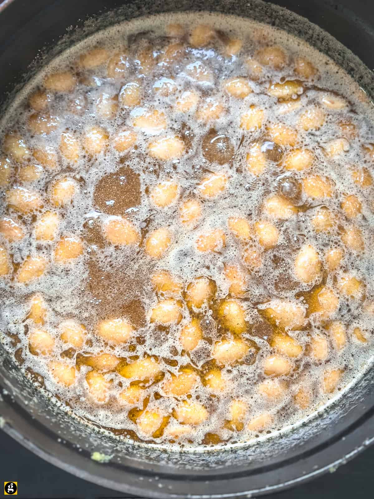 Water poured into the toasted semolina, sugar, and almonds