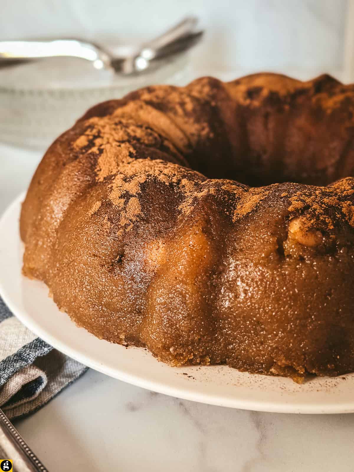 Close-up of Greek halvas showing its glossy semolina texture and a whole almond, dusted with cinnamon
