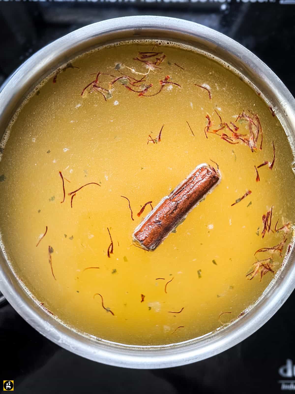Chicken stock, saffron and cinnamon warming up on the stove