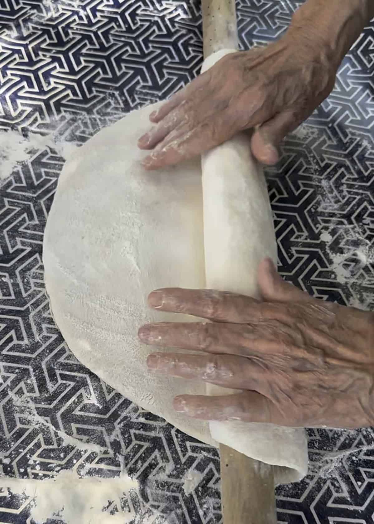 Phyllo dough wrapped around a long narrow rolling pin.