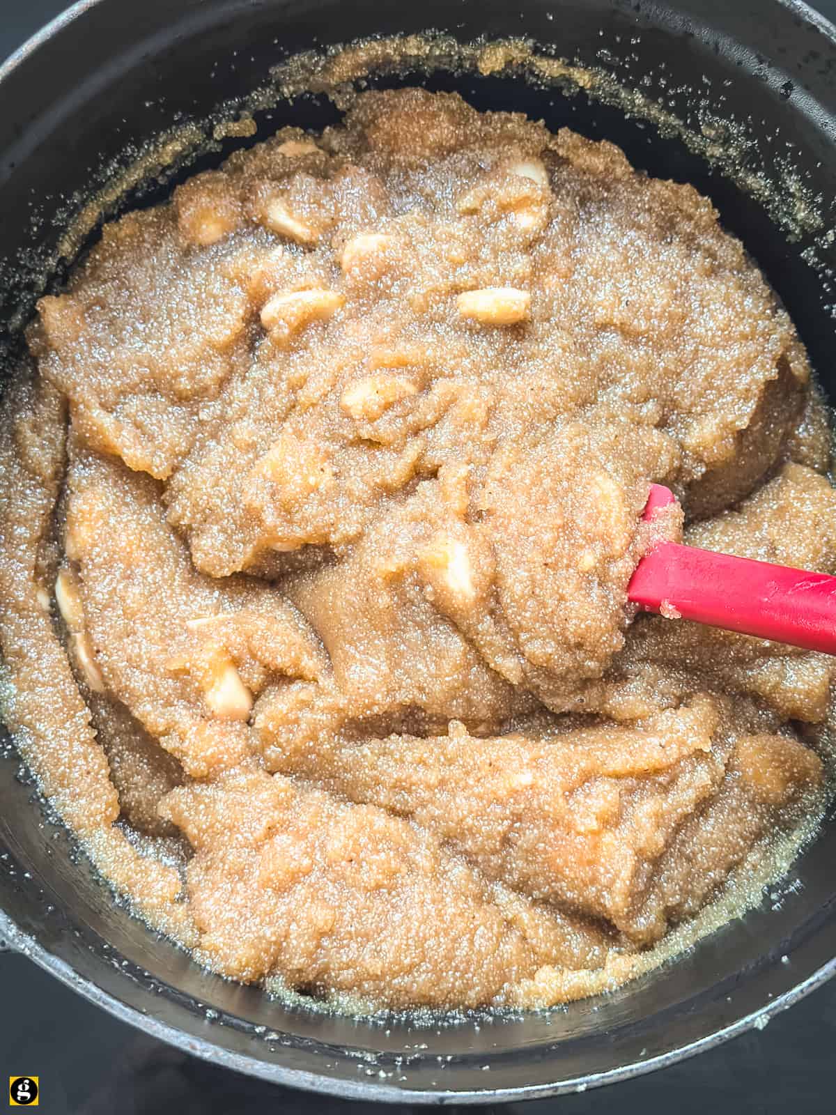 pot with a utensil. Thickened halva mixture pulling away from the sides of the pot