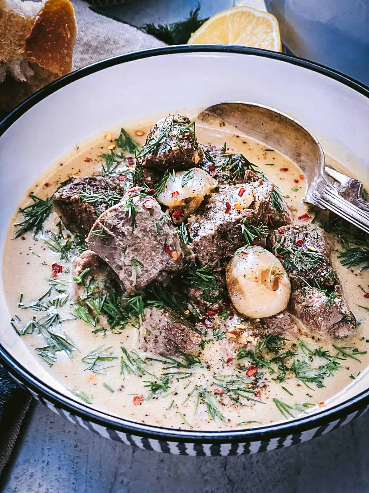 Greek lamb stew with avgolemono sauce on a plate.