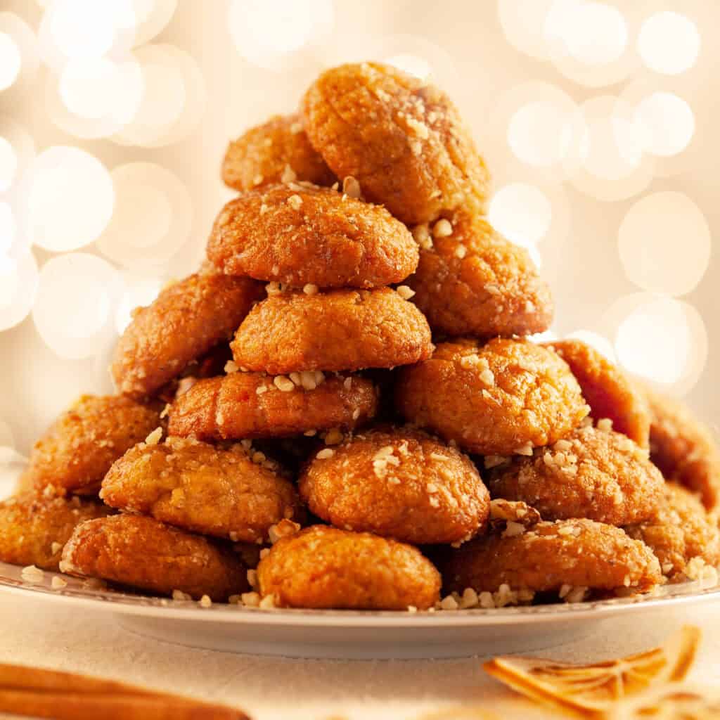 A Greek Christmas table with melomakarona cookies.